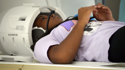 A young girl lying in an MRI machine