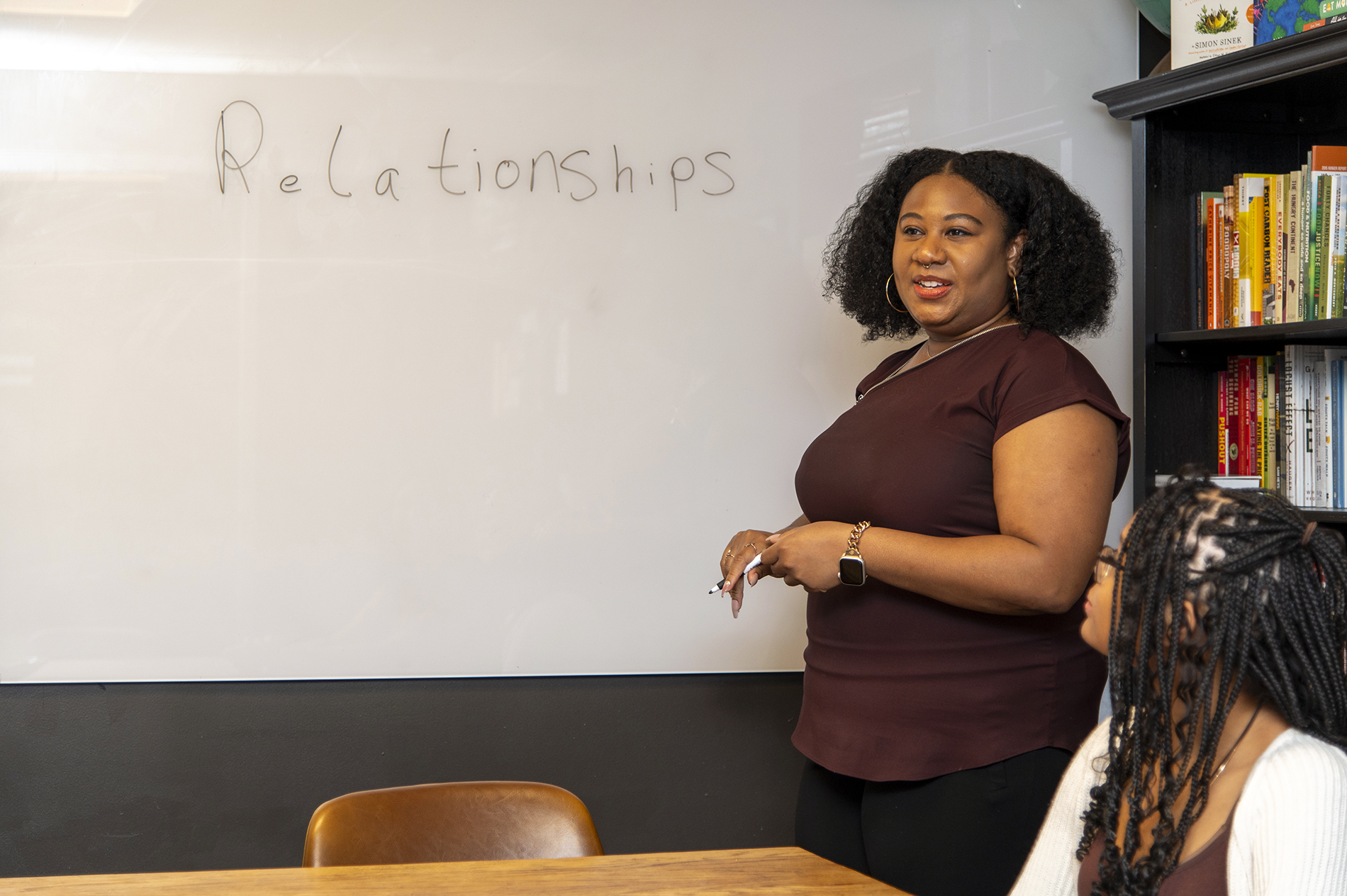 Jenkins at a white board talking to a group.