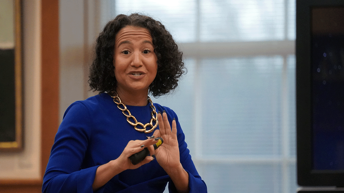 Woman speaking and gesturing to audience