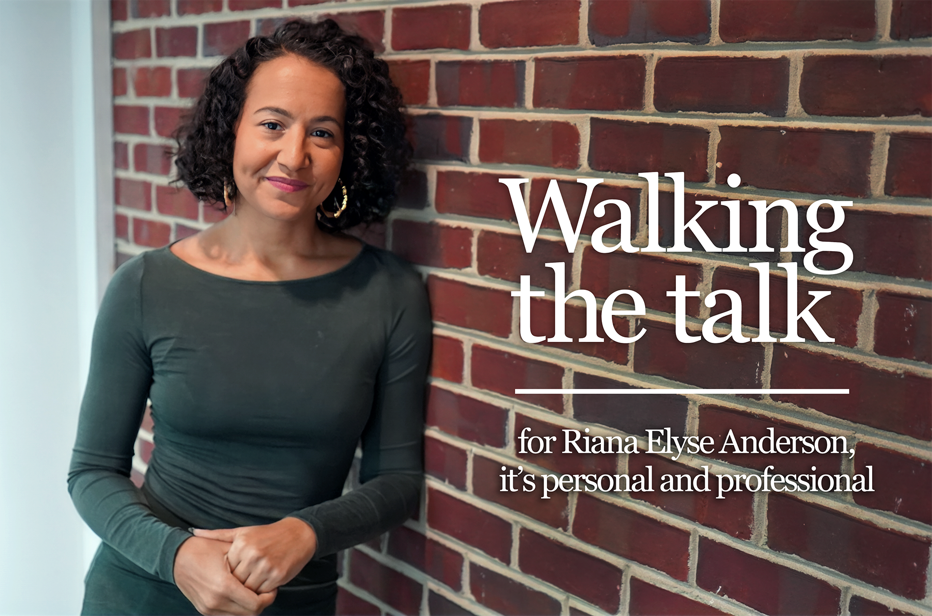Riana_Anderson_Header A woman leaning against a wall and smiling